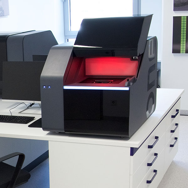 Photo: NanoOne printer on laboratory desk with open lid