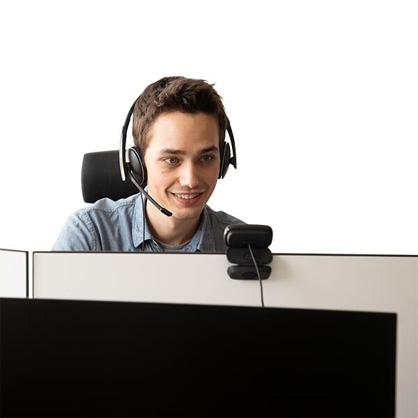 Photo: UpNano employee supporting a customer remotely using a headset and a computer