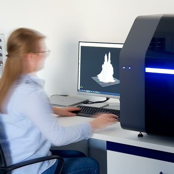 Photo: person working modeling a 3D castle on an computer using THINK 3D software